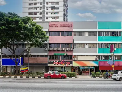 a red car parked in front of a building at OYO 90173 Hotel Mekong in Kuala Lumpur