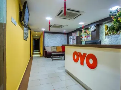 a lobby of a restaurant with a sign on a counter at OYO 90173 Hotel Mekong in Kuala Lumpur