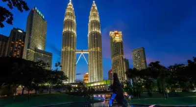 a group of tall skyscrapers in a city at night at Grand Barakah Hotel in Kuala Lumpur