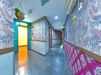 a hallway with colorful walls and a hallway with at Capital O 90788 New Hotel 33 Permaisuri in Kuala Lumpur