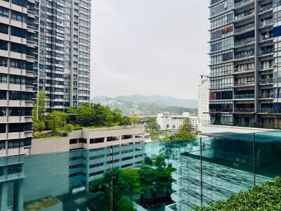 a building with a swimming pool in the middle of two tall buildings at Arte Plus by Willow Trip in Ampang