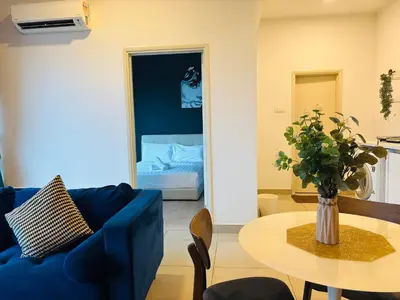 a living room with a blue couch and a table at Arte Plus by Willow Trip in Ampang