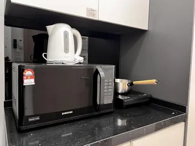 a microwave sitting on top of a kitchen counter at The Luxe by Manhattan Group in Kuala Lumpur