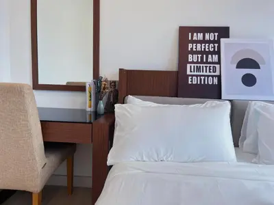 a bedroom with a desk and a bed with a pillow at Arte Plus by Manhattan Group in Kuala Lumpur