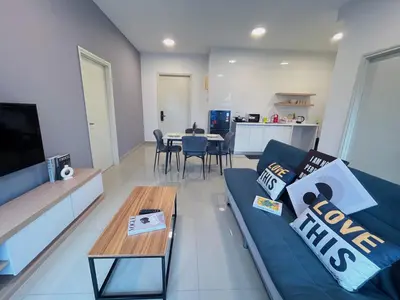 a living room with a blue couch and a table at Arte Plus by Manhattan Group in Kuala Lumpur