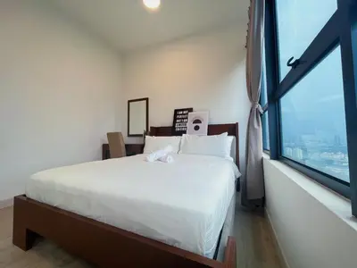 a bedroom with a bed and a large window at Arte Plus by Manhattan Group in Kuala Lumpur