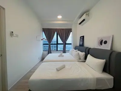 two beds in a room with a window at Arte Plus by Manhattan Group in Kuala Lumpur