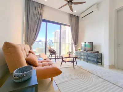 a living room with a couch and a television at Lucentia Residences by Manhattan Group in Kuala Lumpur