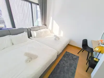 a white couch in a room with a large window at Lucentia Residences by Manhattan Group in Kuala Lumpur