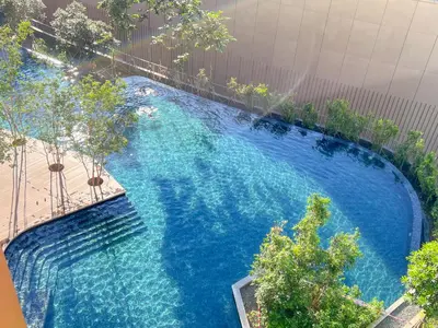 an overhead view of a large blue swimming pool at Lucentia Residences by Manhattan Group in Kuala Lumpur