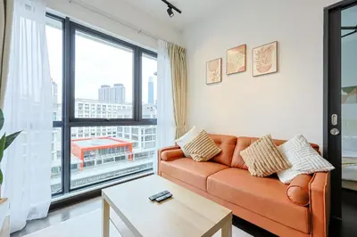 a living room with a couch and a large window at V Residence Sunway Velocity Kuala Lumpur by Vivid Stay in Kuala Lumpur