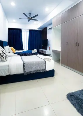 a bedroom with two beds and a ceiling fan at Taragon Bukit Bintang City Centre in Kuala Lumpur