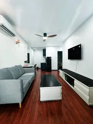 a living room with a couch and a flat screen tv at Taragon Bukit Bintang City Centre in Kuala Lumpur