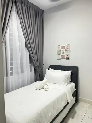 a bedroom with a bed with white sheets and a window at Diamond Suite Homestay in Kuala Lumpur
