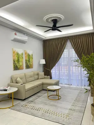 a living room with a couch and a ceiling fan at Diamond Suite Homestay in Kuala Lumpur