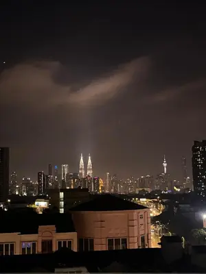 a view of a city skyline at night at Diamond Suite Homestay in Kuala Lumpur