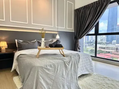 a bedroom with a large bed with a table on it at 8 Pax Continew 2R2B Premium Amenities 10mins to KLCC TRX in Kuala Lumpur