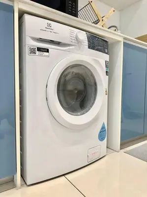 a washing machine is sitting in a room at 8 Pax Continew 2R2B Premium Amenities 10mins to KLCC TRX in Kuala Lumpur