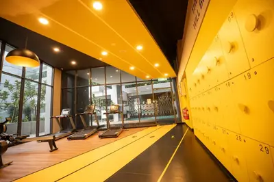 an empty gym with yellow walls and a yellow ceiling at Neu Suites By Cozy Unit L30RB 2PAX near KLCC & Jelatek LRT in Kuala Lumpur