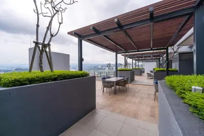 a balcony with a table and chairs on a building at Neu Suites By Cozy Unit L30RB 2PAX near KLCC & Jelatek LRT in Kuala Lumpur