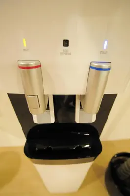 a coffee machine with two cups on a counter at Hotel Mezzo in Kuala Lumpur