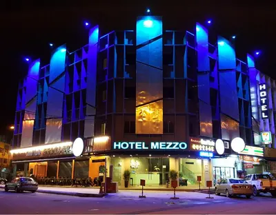 a hotel mezco building at night with blue lights at Hotel Mezzo in Kuala Lumpur