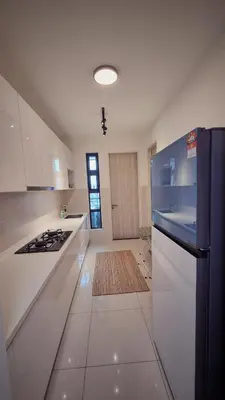 a large white kitchen with a stove top oven at KLCC Legasi Executive Suite Apartment in Kuala Lumpur