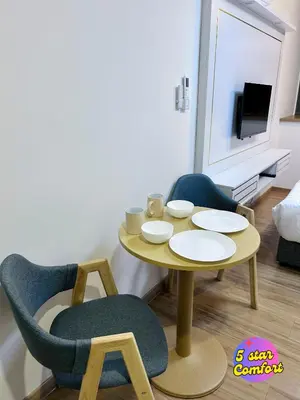 a living room with a table and two chairs at 5 Star Comfort Riveria City KL Sentral 4 pax infinity pool in Kuala Lumpur