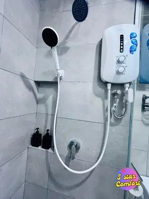 a white shower head on a wall in a bathroom at 5 Star Comfort Riveria City KL Sentral 4 pax infinity pool in Kuala Lumpur
