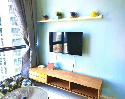 a living room with a flat screen tv on a wall at Home Sweet Home at Robertson Bukit Bintang,TRX,KLCC in Kuala Lumpur