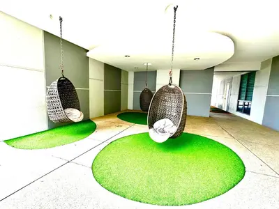a room with three hanging chairs and green carpet at Home Sweet Home at Robertson Bukit Bintang,TRX,KLCC in Kuala Lumpur