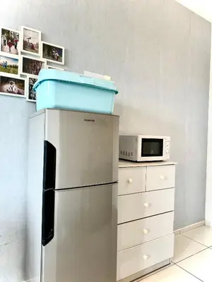 a kitchen with a refrigerator and a microwave at Home Sweet Home at Robertson Bukit Bintang,TRX,KLCC in Kuala Lumpur
