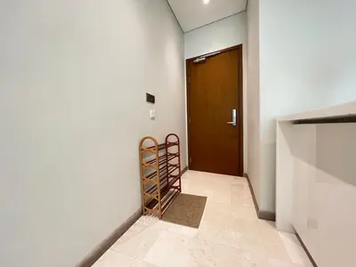 a hallway with a door and a rack of wine bottles at Sky Suites Charming 3BR Suite KLCC View in Kuala Lumpur
