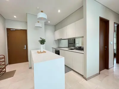 a kitchen with white cabinets and a white counter top at Sky Suites Charming 3BR Suite KLCC View in Kuala Lumpur