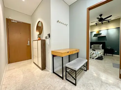 a room with a table and a mirror and a bed at Sky Suites Deluxe 3BR Suite at KLCC in Kuala Lumpur