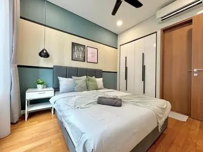 a bedroom with a large bed in a room at Sky Suites Deluxe 3BR Suite at KLCC in Kuala Lumpur