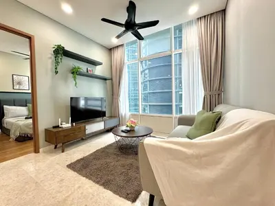 a living room with a ceiling fan and a television at Sky Suites Deluxe 3BR Suite at KLCC in Kuala Lumpur