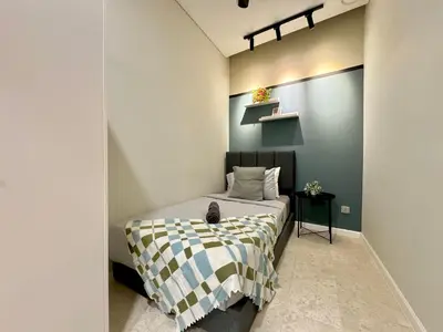 a bedroom with a bed with a black and white blanket at Sky Suites Deluxe 3BR Suite at KLCC in Kuala Lumpur