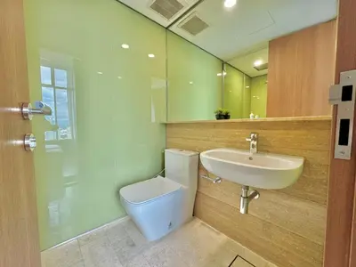 a bathroom with a toilet and a sink and a mirror at Sky Suites Wonder 2BR Suite KLCC View in Kuala Lumpur
