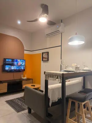 a living room with a table and a tv at Downtown Retreat 2BR at Neu Suites, Kuala Lumpur in Kuala Lumpur