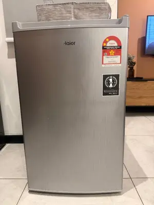 a metal refrigerator is sitting on a floor at Downtown Retreat 2BR at Neu Suites, Kuala Lumpur in Kuala Lumpur