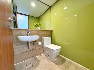 a bathroom with a sink and a toilet and a mirror at Sky Suites Upper 3BR Suite at KLCC in Kuala Lumpur