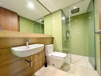 a bathroom with a sink and a toilet and a shower at Sky Suites Modern 3BR Family Suite at KLCC in Kuala Lumpur