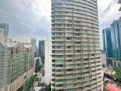 a tall building with many windows in a city at Sky Suites Modern 3BR Family Suite at KLCC in Kuala Lumpur