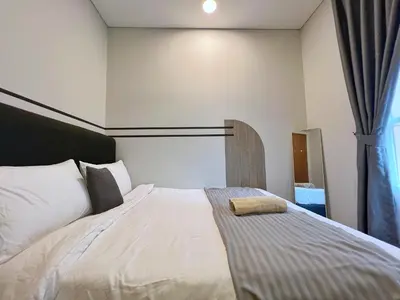 a bedroom with a large bed with a window at Sky Suites Modern 3BR Family Suite at KLCC in Kuala Lumpur
