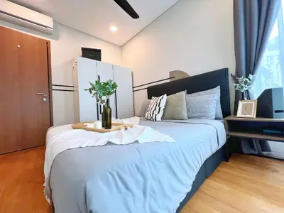 a bedroom with a large bed with a table on it at Sky Suites Modern 3BR Family Suite at KLCC in Kuala Lumpur