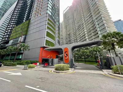 a parking lot in a city with tall buildings at Sky Suites Modern 3BR Family Suite at KLCC in Kuala Lumpur