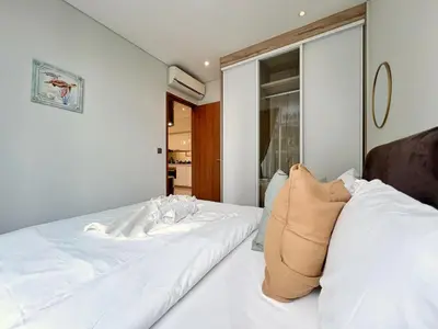 a bedroom with two white beds and a window at Sky Suites Unique 3BR Suite KLCC View in Kuala Lumpur