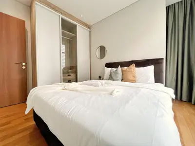 a large white bed in a room with a window at Sky Suites Unique 3BR Suite KLCC View in Kuala Lumpur