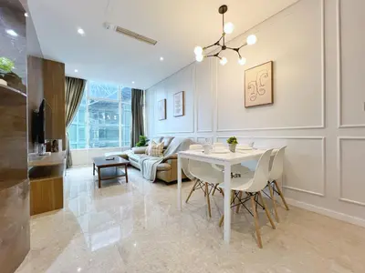 a dining room and living room with a table and chairs at Sky Suites Unique 3BR Suite KLCC View in Kuala Lumpur